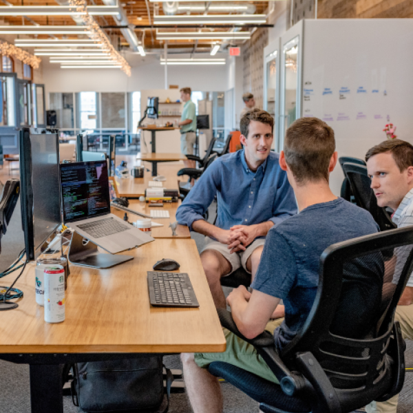 four men discussing in a meeting table